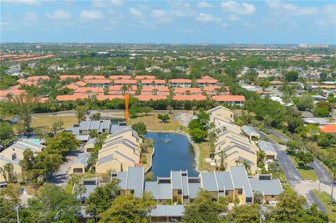 an aerial view of a house with swimming pool and outdoor seating