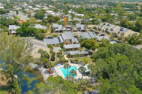 an aerial view of residential houses with outdoor space and street view