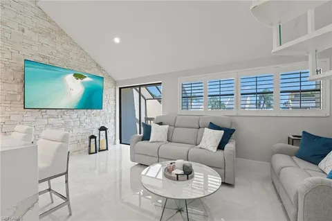 a living room with furniture and kitchen view