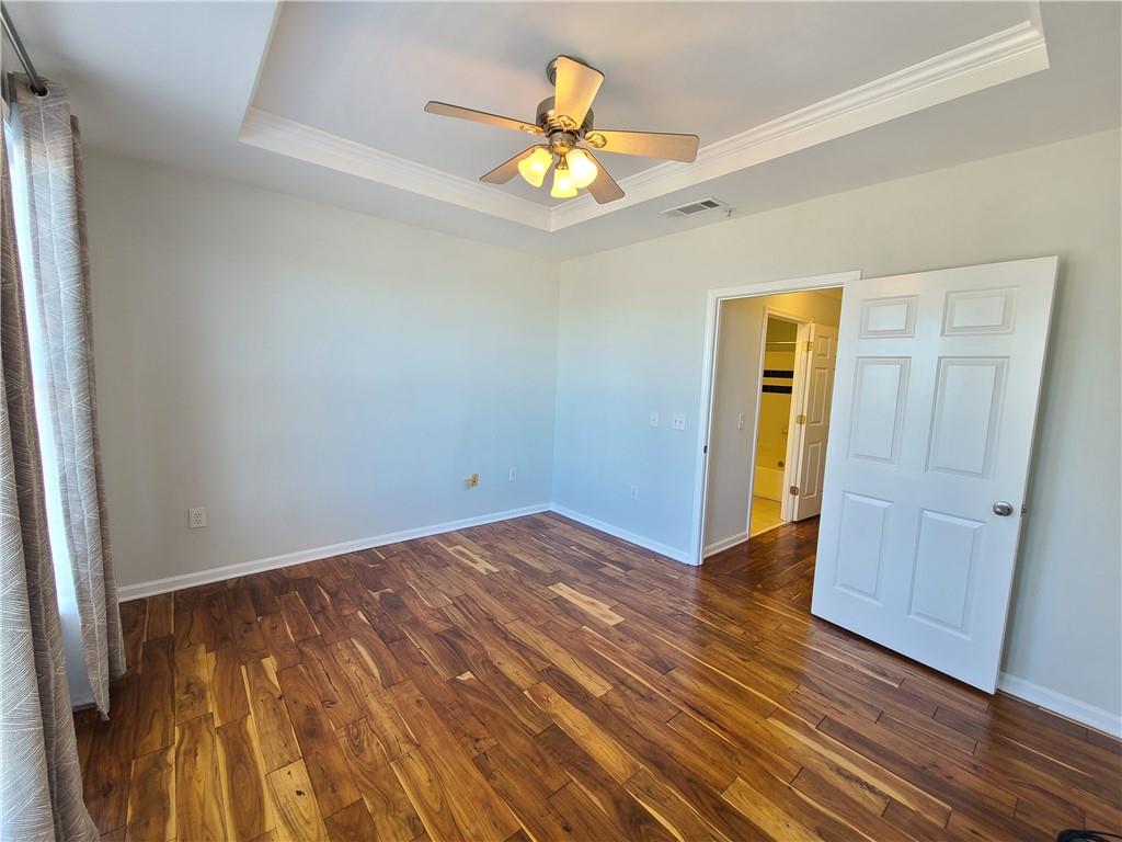 3334 Peachtree Road Northeast, Unit 910 Atlanta, GA 30326 - Photo 11 of 35 a view of an empty room with wooden floor and a window