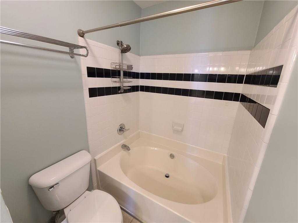 3334 Peachtree Road Northeast, Unit 910 Atlanta, GA 30326 - Photo 12 of 35 a bathroom with a tub and a shower