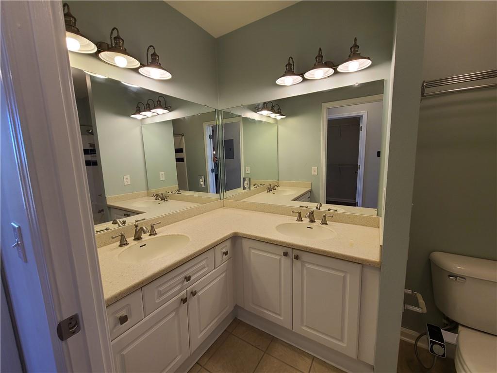 3334 Peachtree Road Northeast, Unit 910 Atlanta, GA 30326 - Photo 13 of 35 a bathroom with a double vanity sink and a mirror