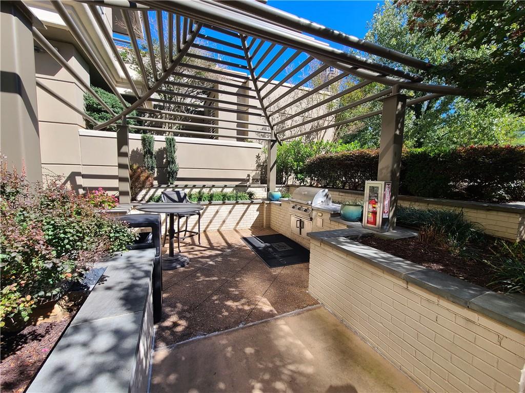 3334 Peachtree Road Northeast, Unit 910 Atlanta, GA 30326 - Photo 19 of 35 a view of a patio with table and chairs potted plants and floor to ceiling window
