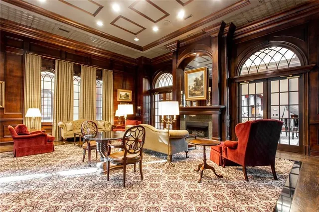 a living room with stainless steel appliances dining table furniture and a flat screen tv