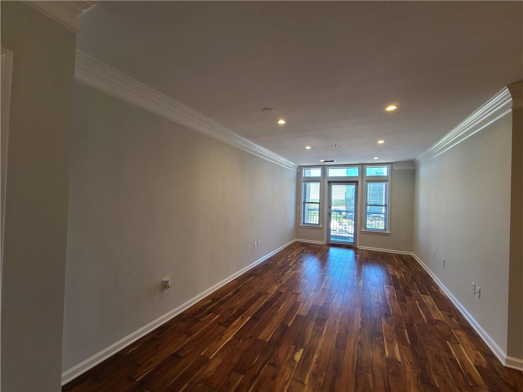 3334 Peachtree Road Northeast, Unit 910 Atlanta, GA 30326 - Photo 5 of 35 a view of empty room with wooden floor and fan