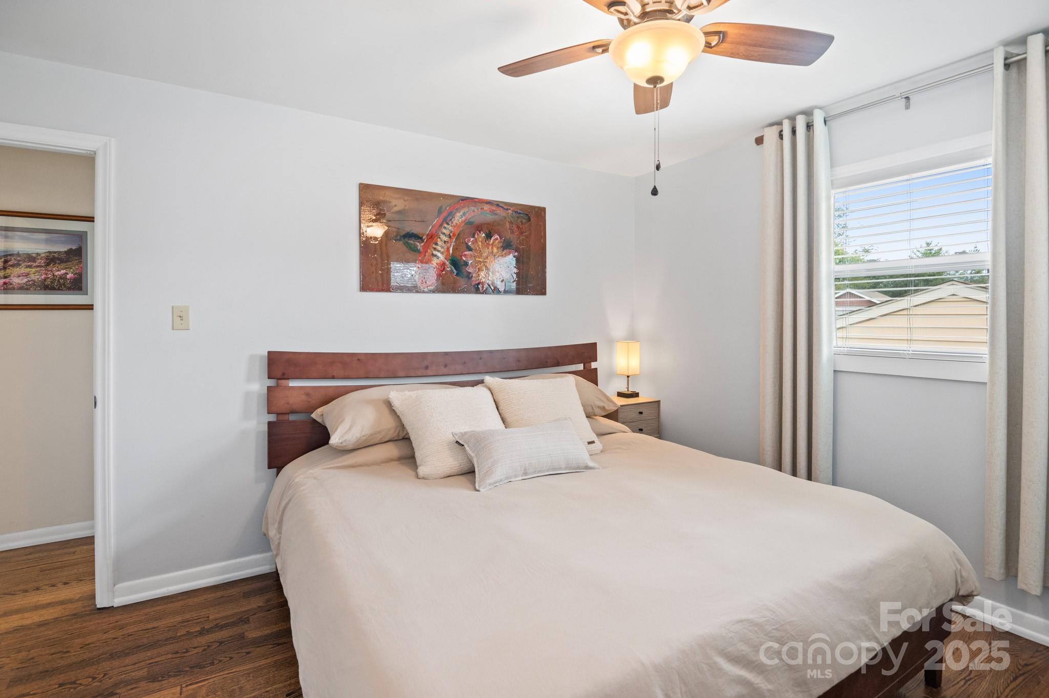 970 West Chapel Road Asheville, NC 28803 - Photo 12 of 19 a bedroom with bed and a chandelier