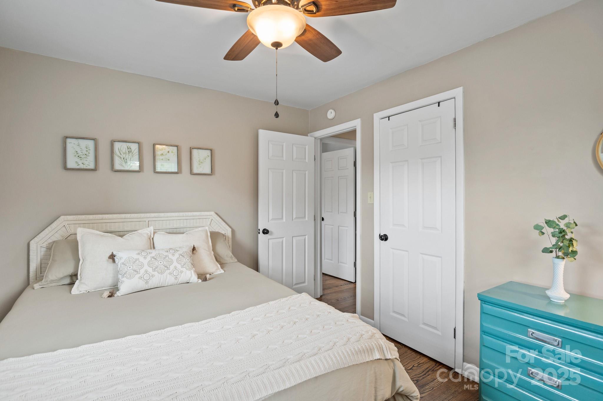 970 West Chapel Road Asheville, NC 28803 - Photo 16 of 19 a bedroom with a bed and a chandelier