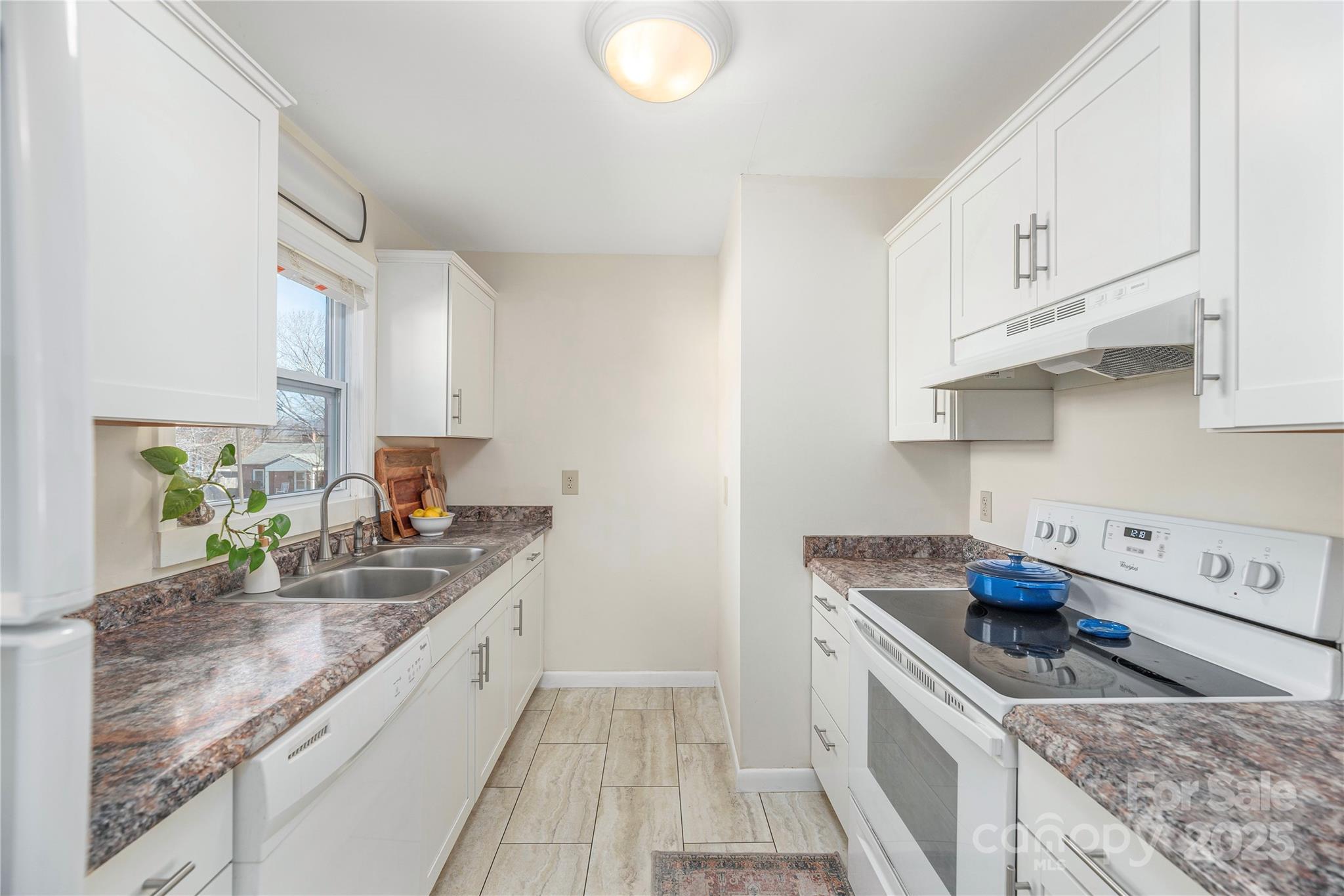 970 West Chapel Road Asheville, NC 28803 - Photo 3 of 19 a kitchen with granite countertop a sink stove and cabinets