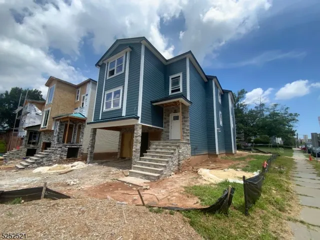 a front view of a house with a yard garage and outdoor seating