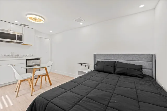 a bedroom with a bed and chair