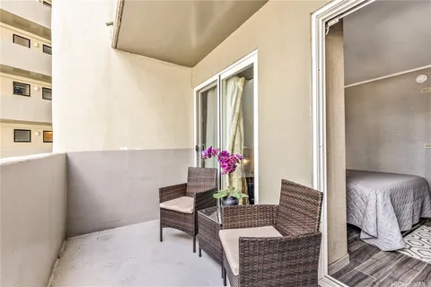 a living room with furniture and flowers