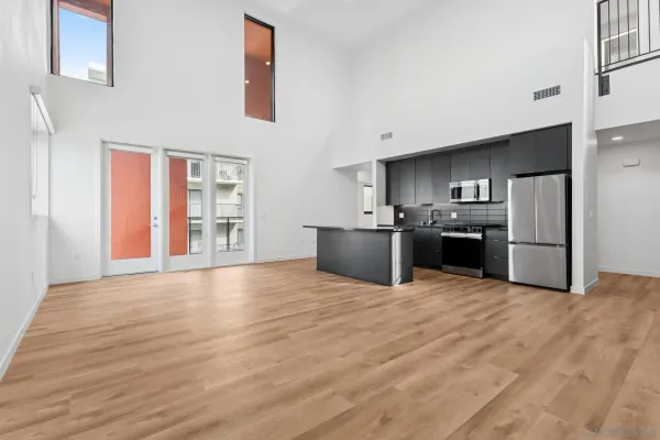 a view of kitchen with a sink and a refrigerator