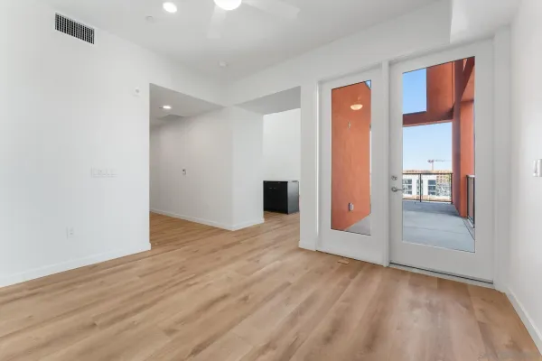 a view of empty room with wooden floor