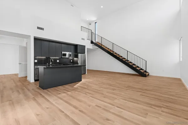 a kitchen with stainless steel appliances kitchen island granite countertop a refrigerator and a stove top oven