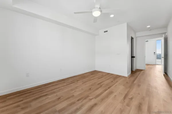 a view of an empty room with wooden floor