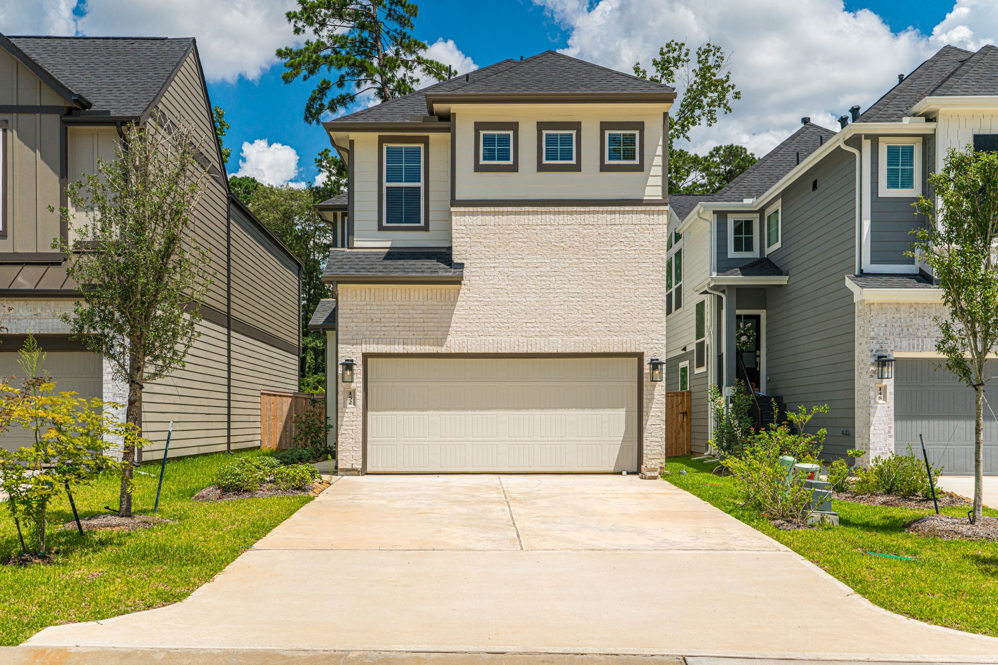 152 Red Cascade Trail Willis, TX 77318 - Photo 1 of 39 a front view of a house with a garden and plants