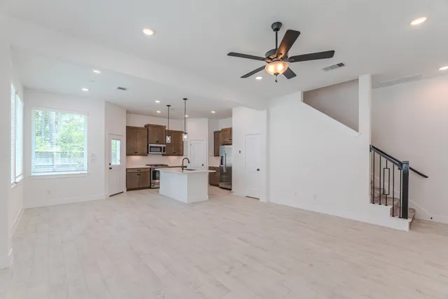 a view of a kitchen with a sink and a ceiling fan