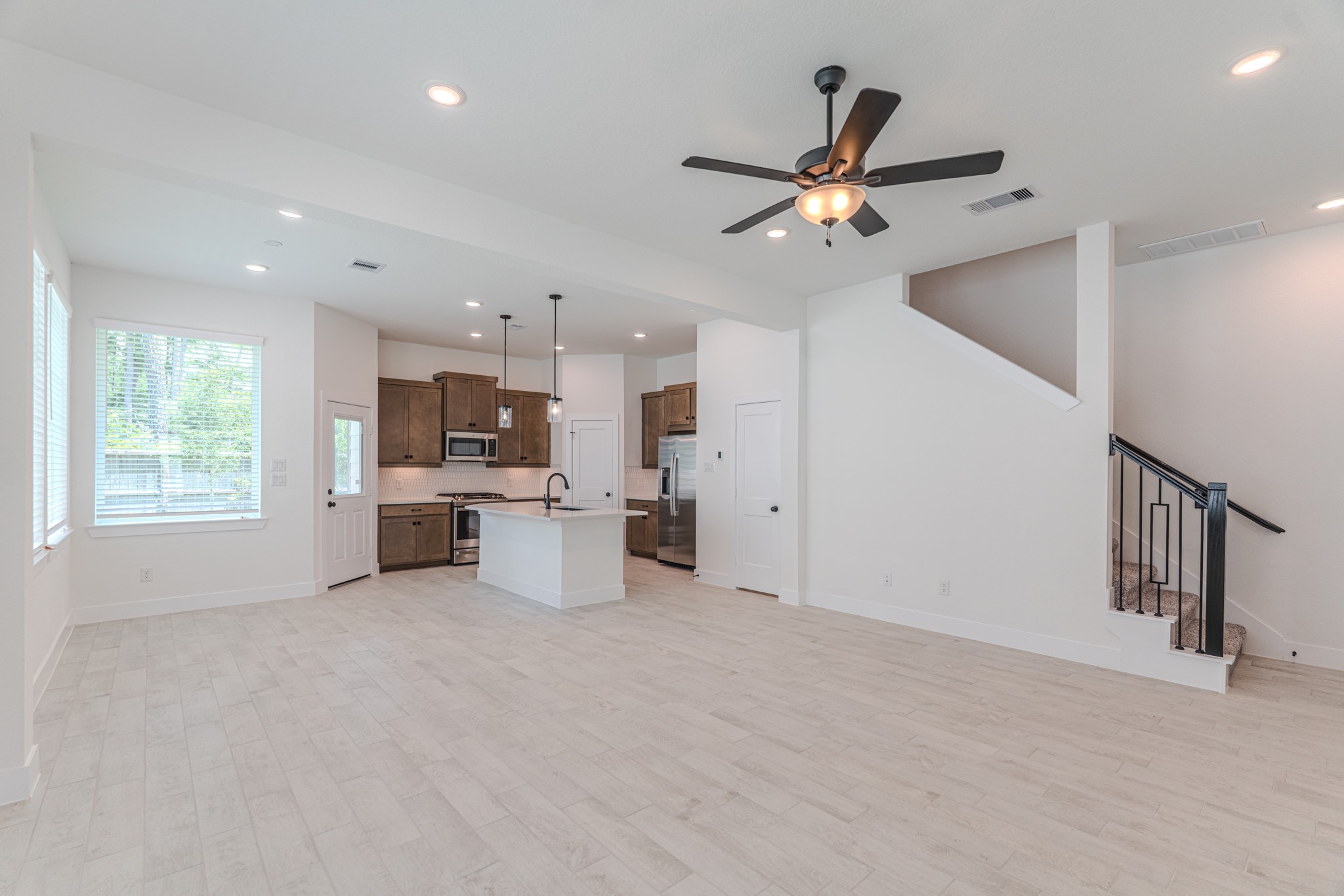 152 Red Cascade Trail Willis, TX 77318 - Photo 12 of 39 a view of a kitchen with a sink and a ceiling fan