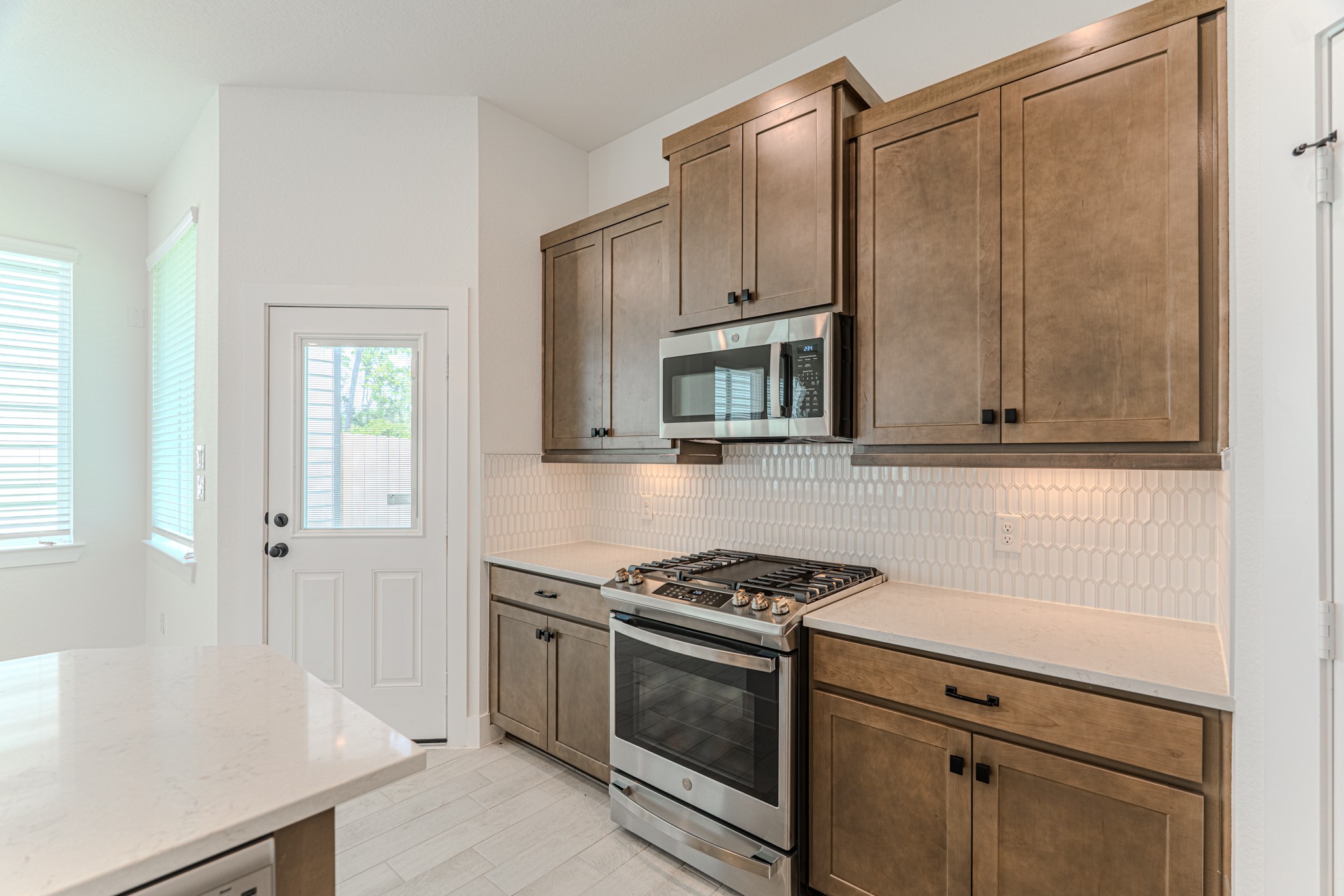 152 Red Cascade Trail Willis, TX 77318 - Photo 16 of 39 a kitchen with white cabinets and appliances