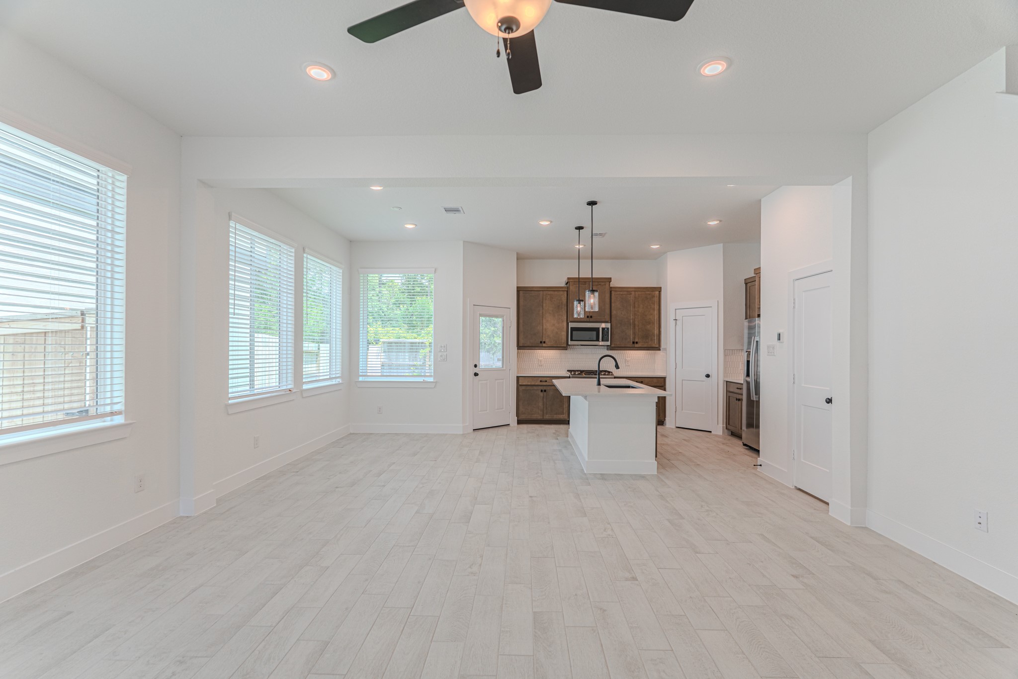 152 Red Cascade Trail Willis, TX 77318 - Photo 19 of 39 a view of a kitchen with kitchen island a sink stainless steel appliances and cabinets