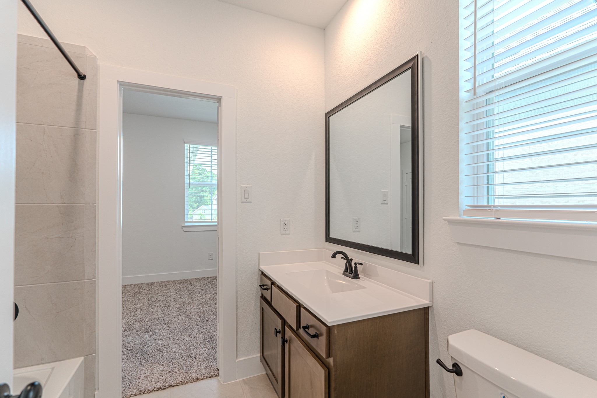 152 Red Cascade Trail Willis, TX 77318 - Photo 23 of 39 a bathroom with a sink a toilet and mirror