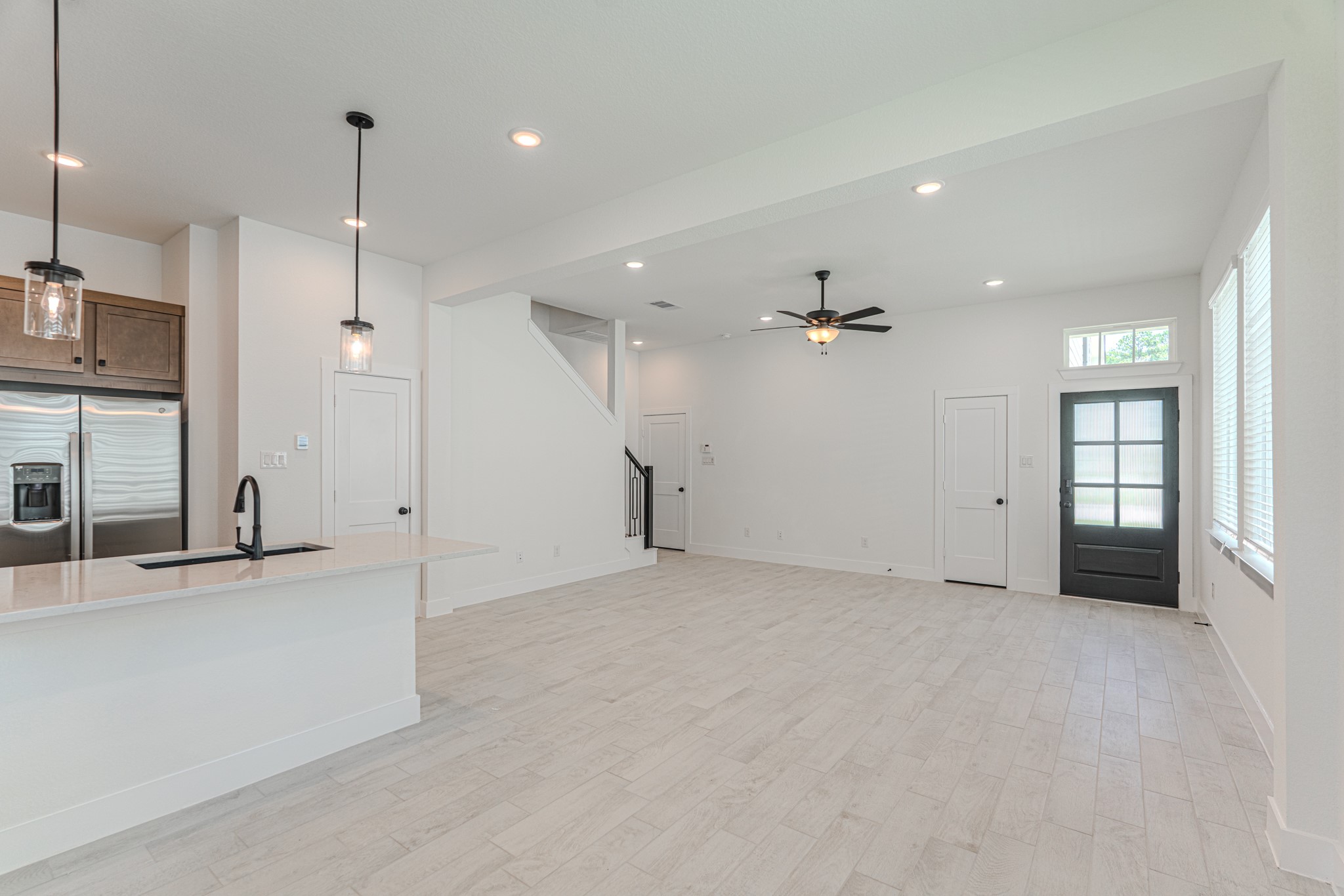 152 Red Cascade Trail Willis, TX 77318 - Photo 26 of 39 an empty room with large windows and ceiling fan