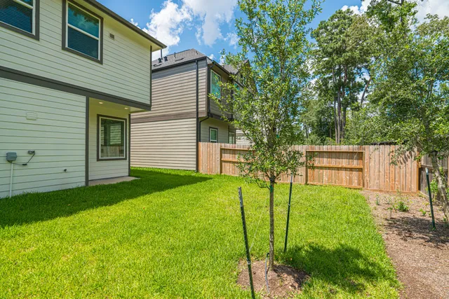 a view of a backyard with a garden and entertaining space