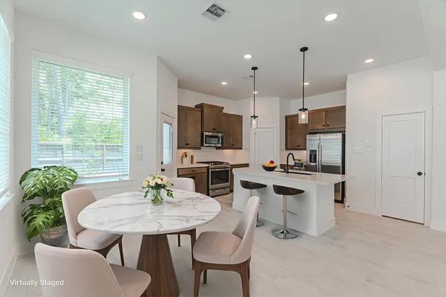 a kitchen with a table and chairs in it