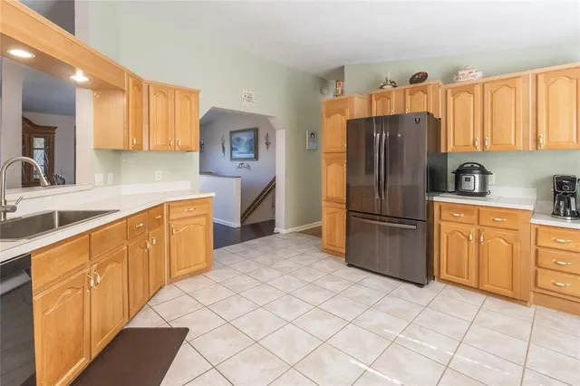 a kitchen with stainless steel appliances a refrigerator sink and cabinets