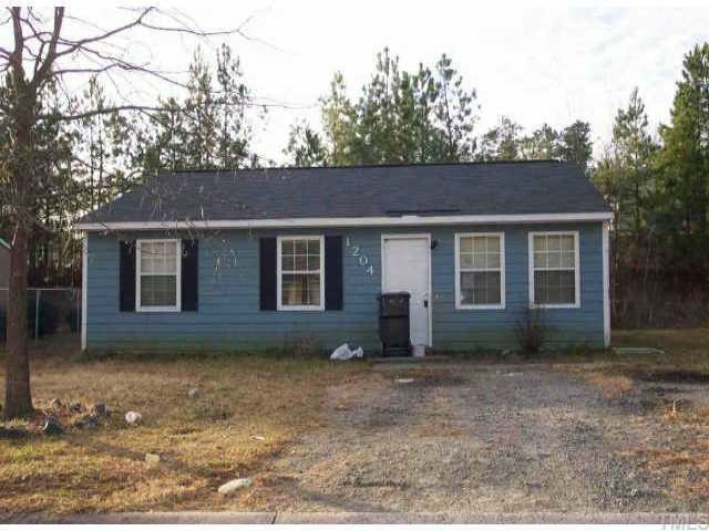 1204 Pecan Place Durham, NC 27704 - Photo 1 of 1 front view of a house with a yard