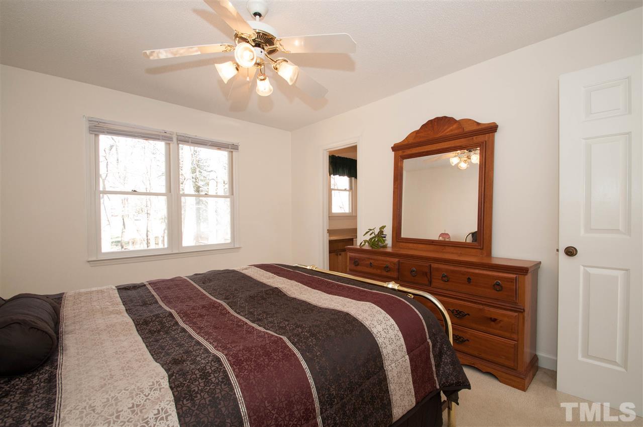 3517 Iron Sight Court Raleigh, NC 27616 - Photo 11 of 22 a bedroom with a bed and a chandelier