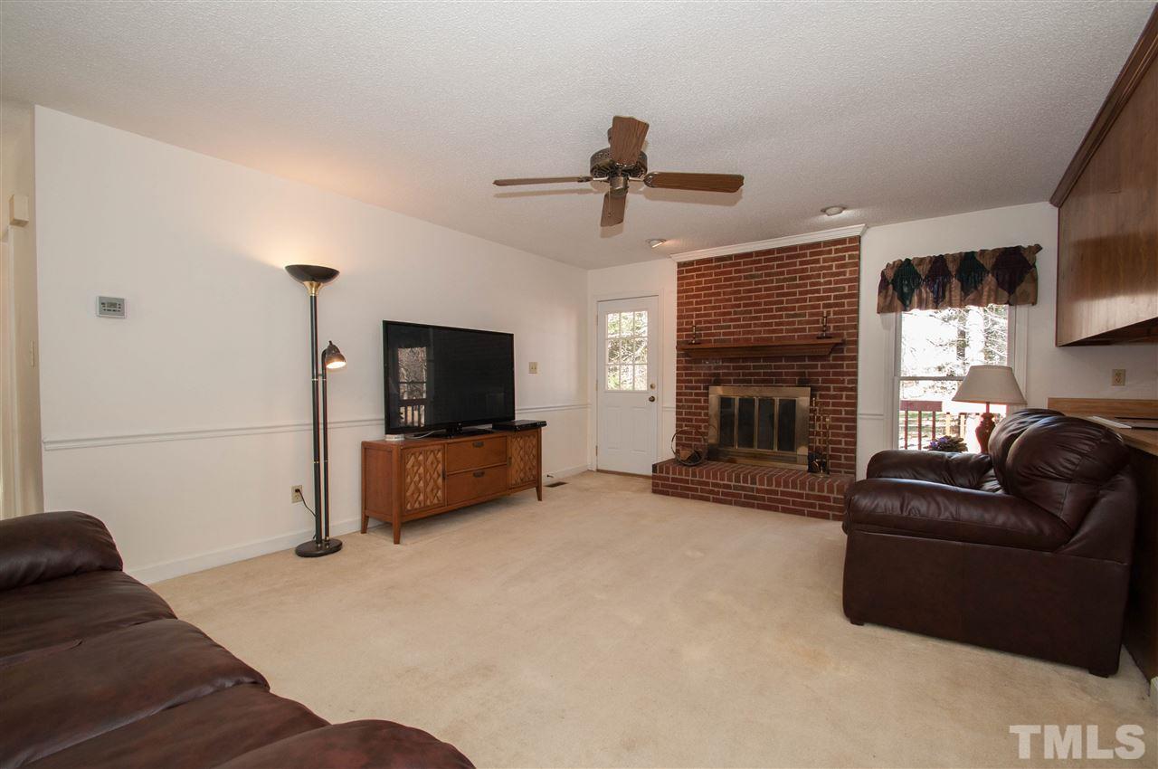 3517 Iron Sight Court Raleigh, NC 27616 - Photo 2 of 22 a living room with furniture a flat screen tv and a fireplace