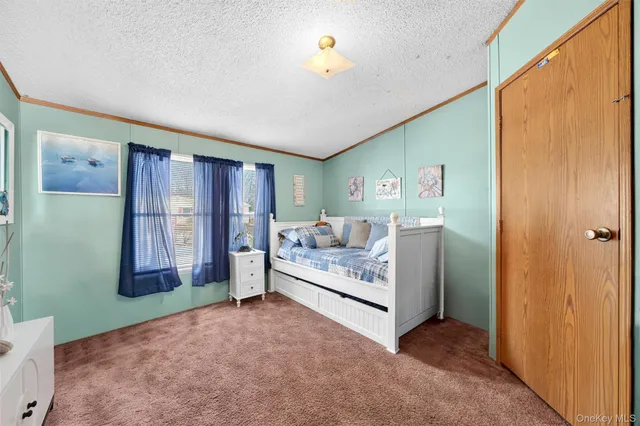 a view of a bedroom with window and furniture