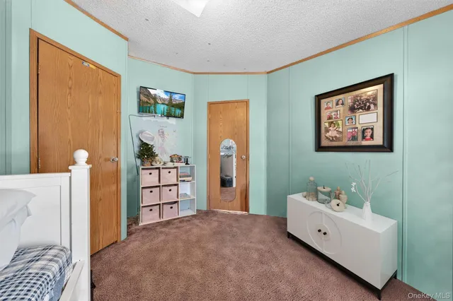 a spacious bedroom with a bed and a dresser