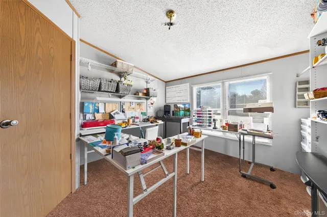 a view of a workspace with lots of furniture and clutter