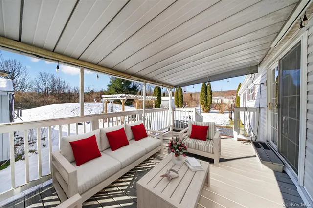 a balcony with furniture and wooden floors