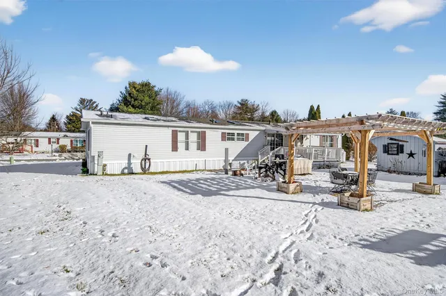 a view of a swimming pool with a patio and a yard