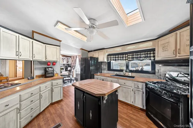 a kitchen with a stove sink and cabinets