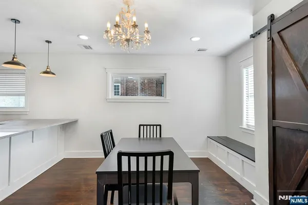 a view of a room with furniture and a chandelier
