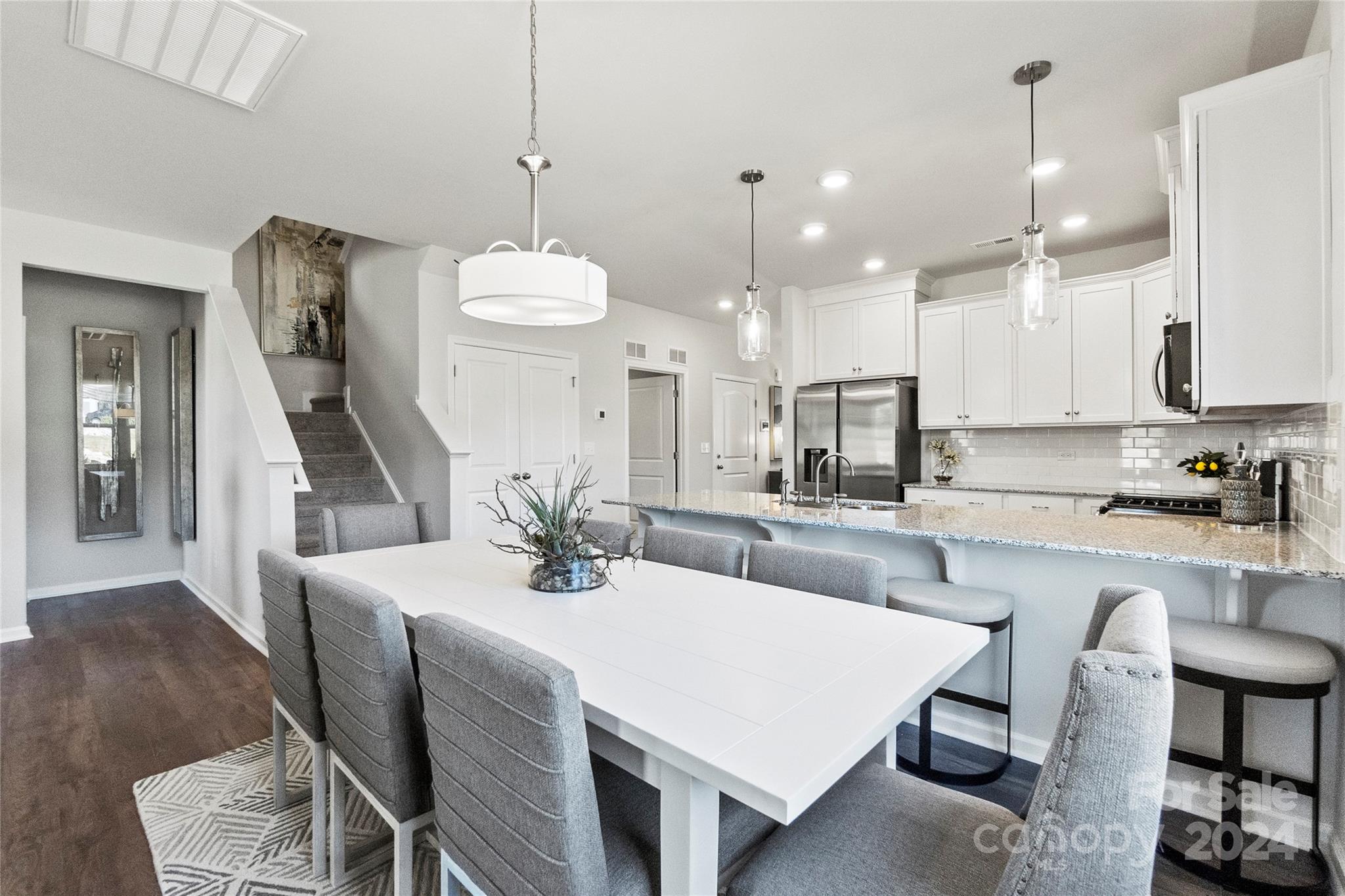 3182 Laurel Brook Drive Denver, NC 28037 - Photo 11 of 35 a kitchen with stainless steel appliances kitchen island granite countertop a dining table chairs sink and cabinets