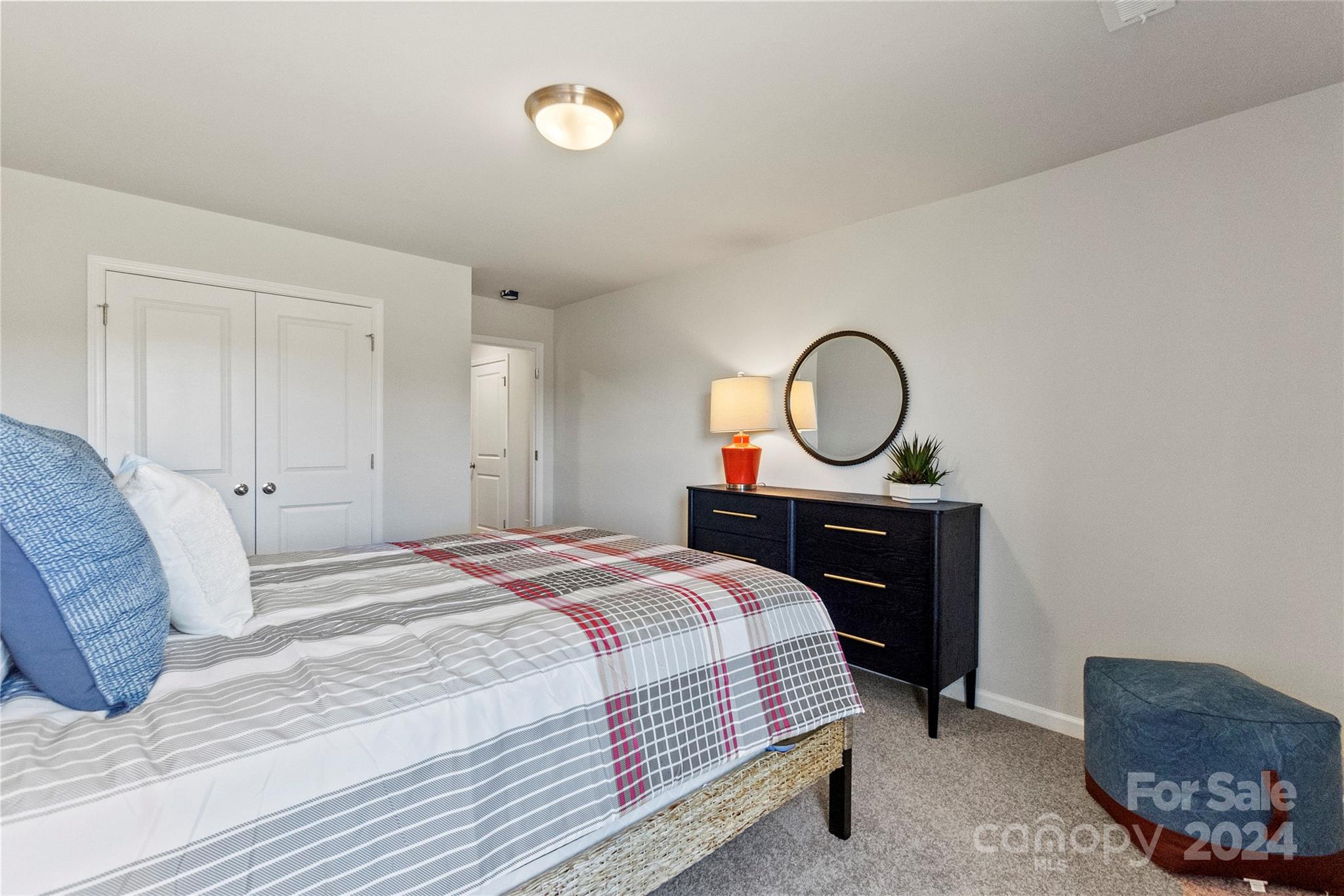 3182 Laurel Brook Drive Denver, NC 28037 - Photo 22 of 35 a bedroom with a bed a mirror and a lamp on dresser