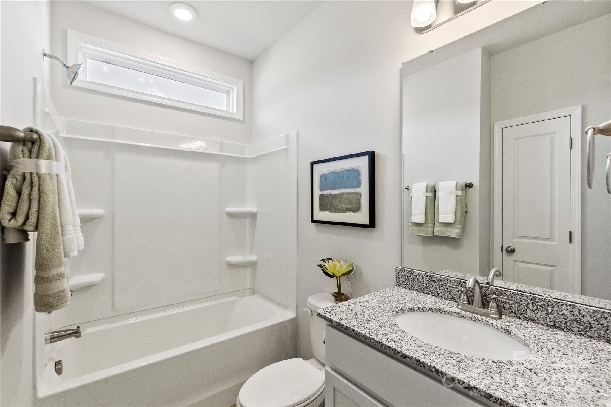 3182 Laurel Brook Drive Denver, NC 28037 - Photo 6 of 35 a bathroom with a granite countertop sink mirror toilet and bathtub