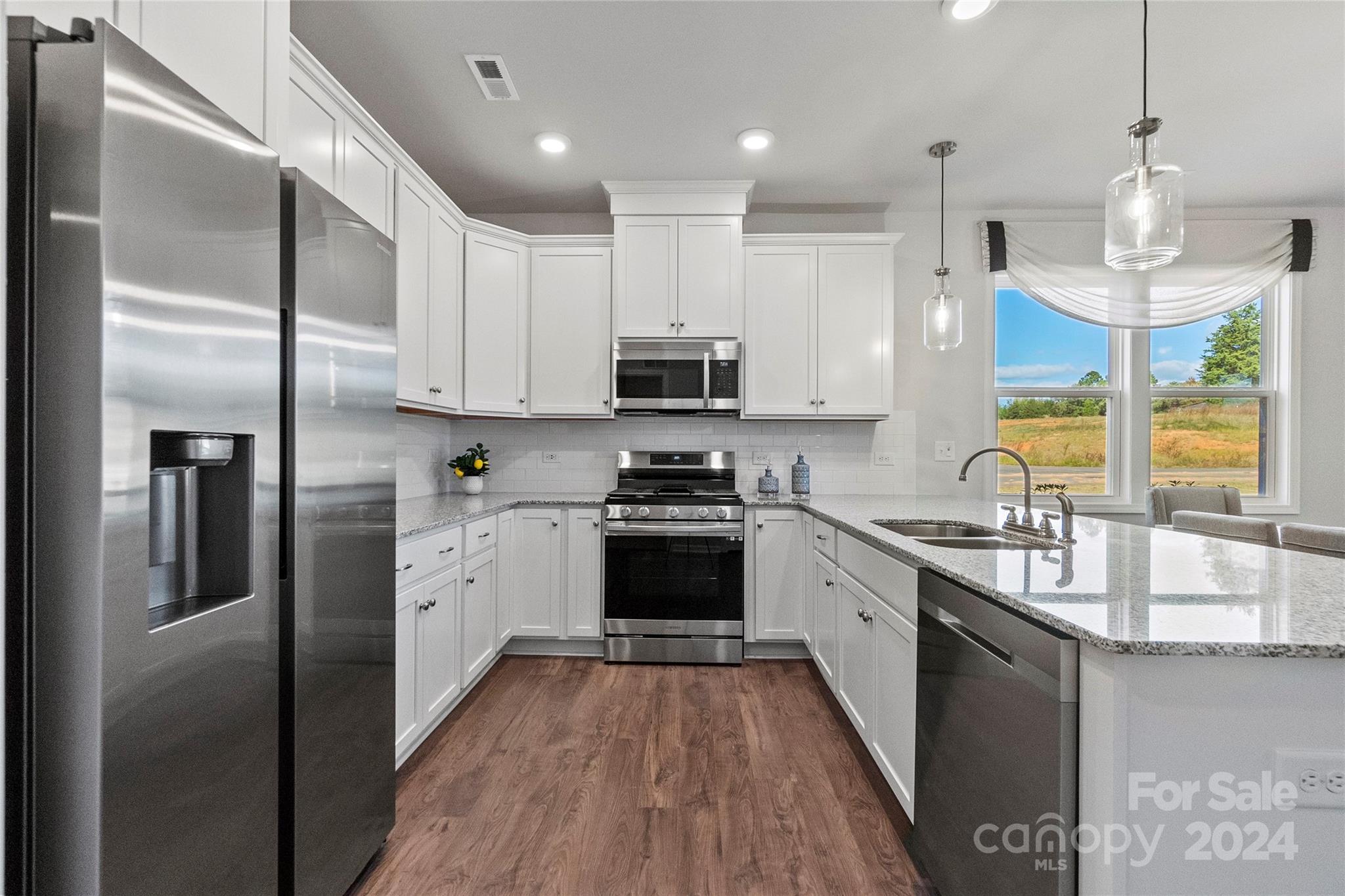 3182 Laurel Brook Drive Denver, NC 28037 - Photo 8 of 35 a kitchen with stainless steel appliances granite countertop a stove a refrigerator and a sink