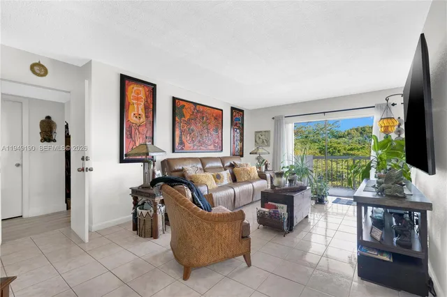 a living room with furniture large window and flat screen tv