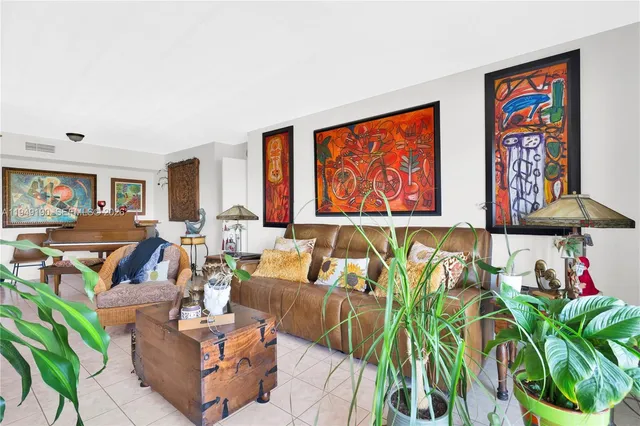 a living room with furniture a rug and a potted plant