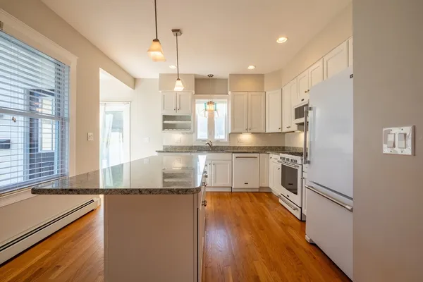 a kitchen with stainless steel appliances granite countertop a refrigerator a sink and a stove