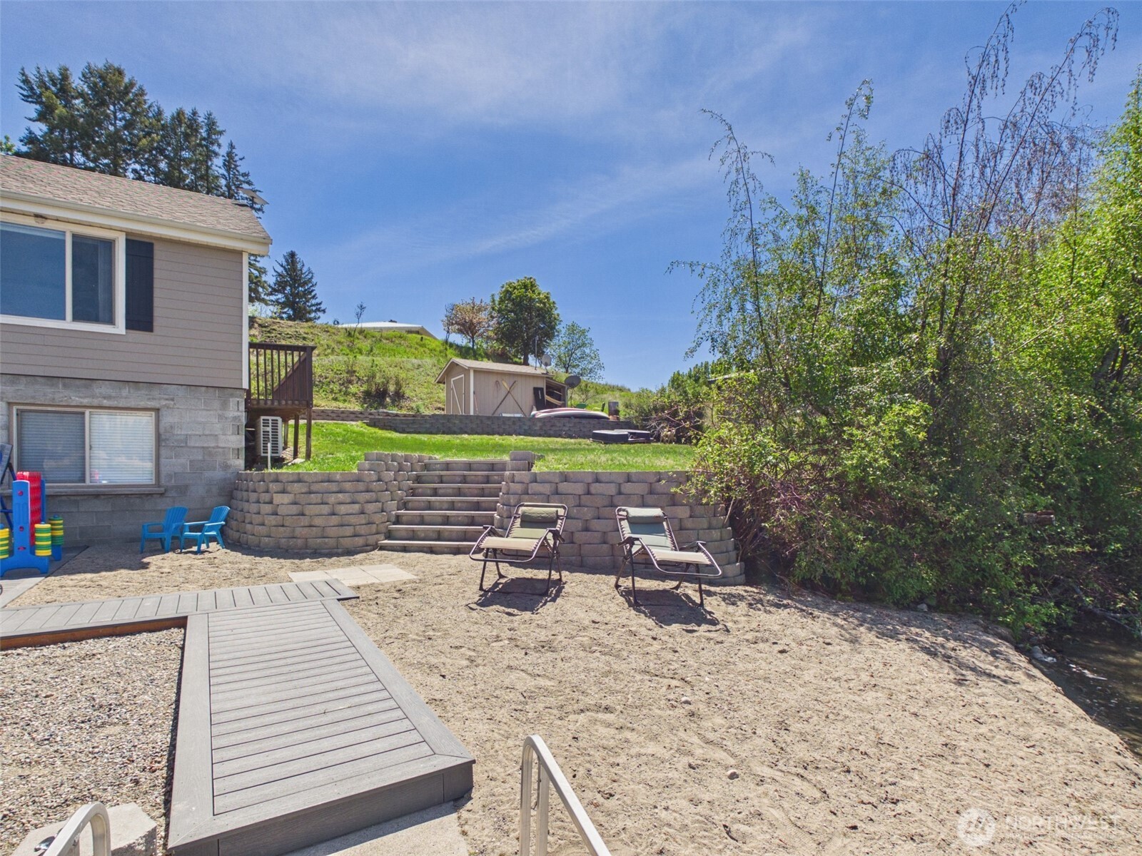 6 Marions Cove Road Republic, WA 99166 - Photo 25 of 33 a view of a backyard with plants and brick wall