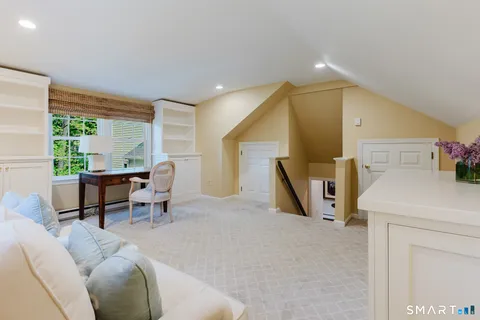 a living room with furniture a window and a table