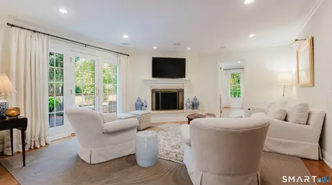 a living room with furniture fireplace and a flat screen tv