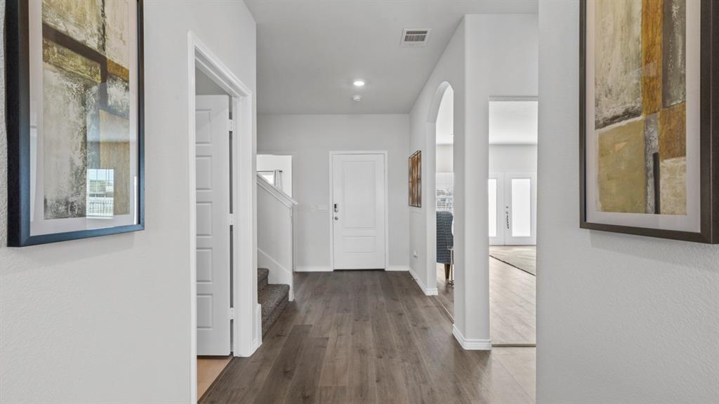 500 Range Road Caddo Mills, TX 75135 - Photo 24 of 35 Inviting entry hall featuring wood-finish flooring, recessed lighting, arched doorways, and a prominent white front door